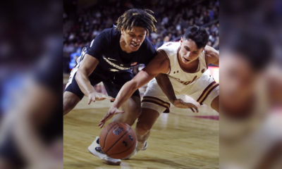 Photo of Chris Herren Jr. diving for a loose ball.