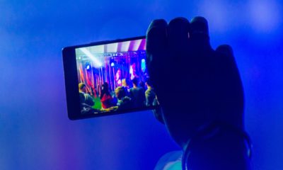 Photo of a parent videoing a school musical with a smart phone