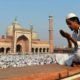 A Muslim offers prayers outside of a mosque.