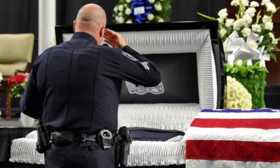 Photo of mourners and police officers from around the country attending a memorial service