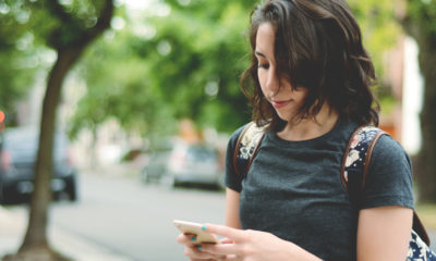Photo of a woman checking her smartphone for messages