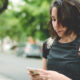 Photo of a woman checking her smartphone for messages