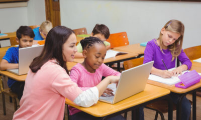 Shutterstock photo of teacher with young math students at their desks