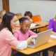 Shutterstock photo of teacher with young math students at their desks