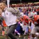 Photo of Urban Meyer running onto the field with his team