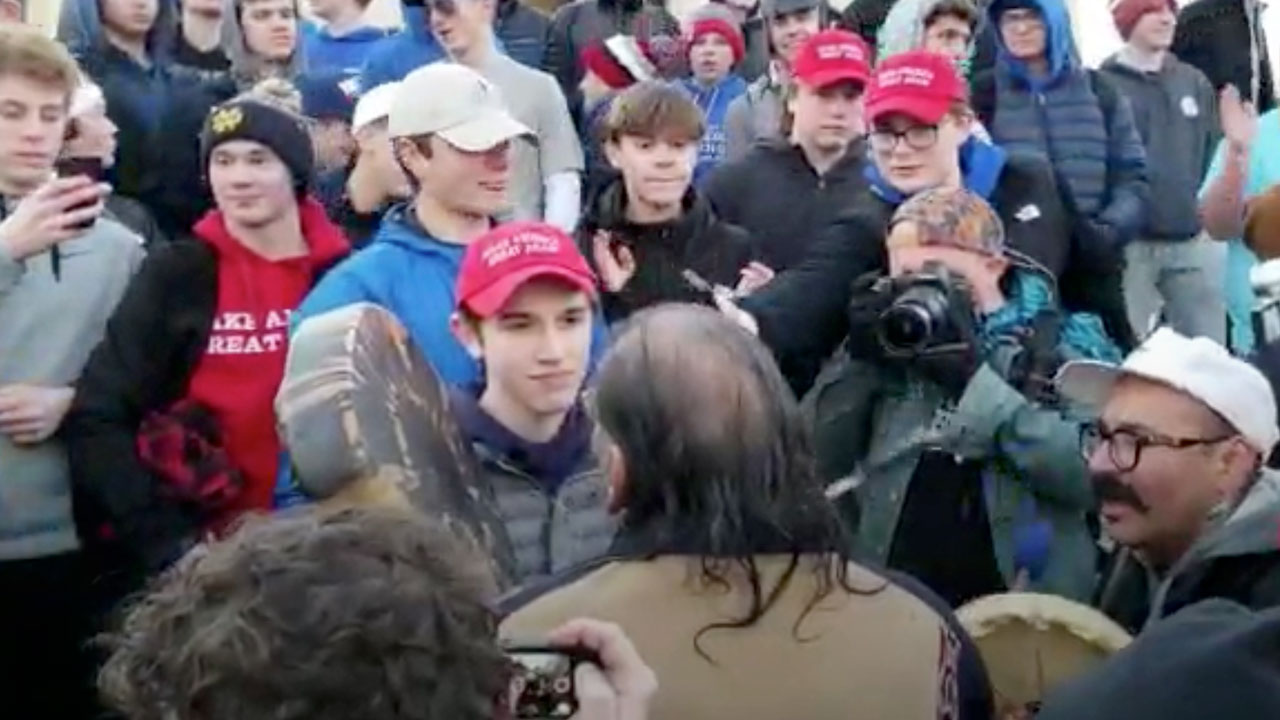Photo of youths confronting Native American leader in front of the Lincoln Memorial