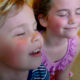 Young children cooling off in front of air conditioner.