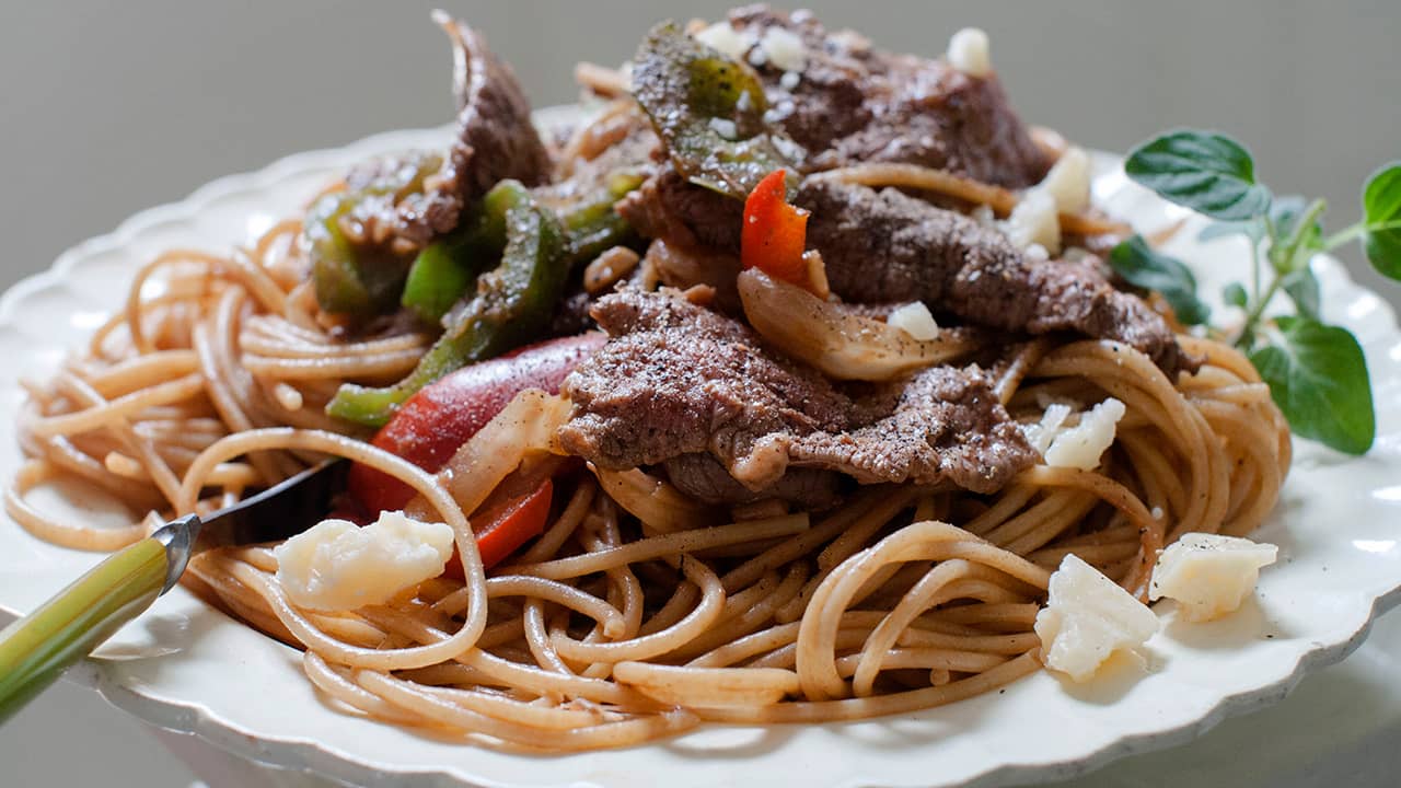 Photo of a dish of steak and cheese pasta