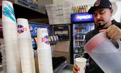 Photo of Gustavo Munoz filling a cup with water