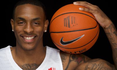 Photo of Deshon Taylor with a basketball on his shoulder