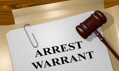 Photo of arrest warrant and gavel