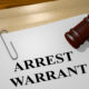 Photo of arrest warrant and gavel