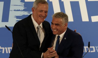 Photo of Benny Gantz, left, smiles with Yair Lapid