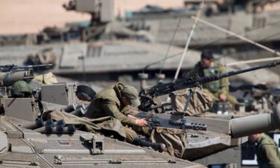Photo of Israeli soldiers working on their tanks