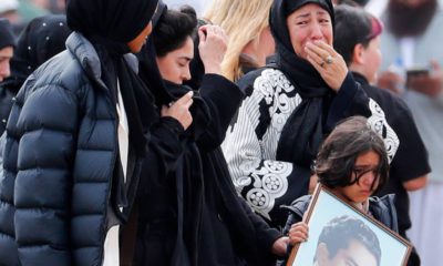 Photo of mourners arriving at a burial service