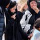 Photo of mourners arriving at a burial service