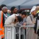 Photo of mourners attending service for a victim of the mosque shootings