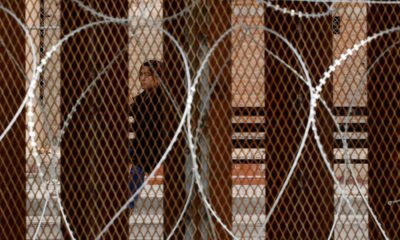 Photo of razor wire covered border wall