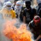 Photo of a Palestinian protester burning a tyre during clashes with Israeli troops