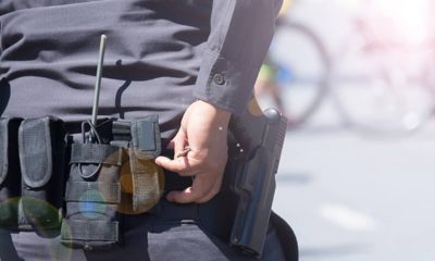 Photo of an officer ready to draw his gun