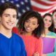 Photo of students posing in front of an American flag