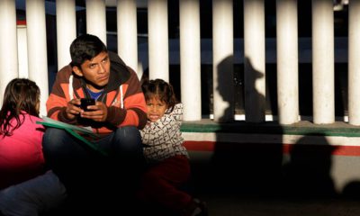 Photo of a migrant and his children