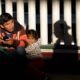 Photo of a migrant and his children