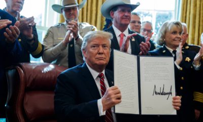 Photo of President Donald Trump after signing his first veto in the Oval Office