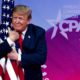 Photo of President Donald Trump hugging an American flag