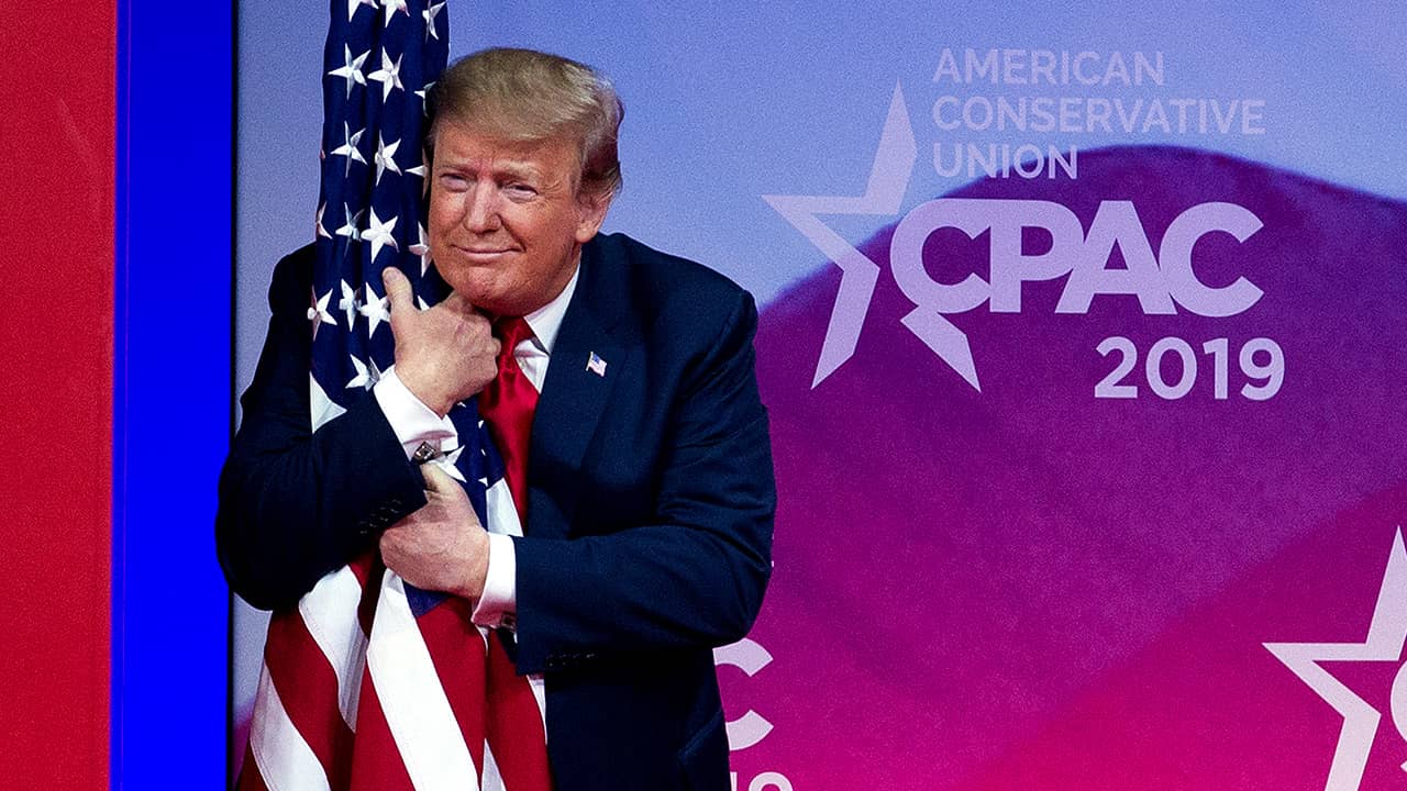 Photo of President Donald Trump hugging an American flag