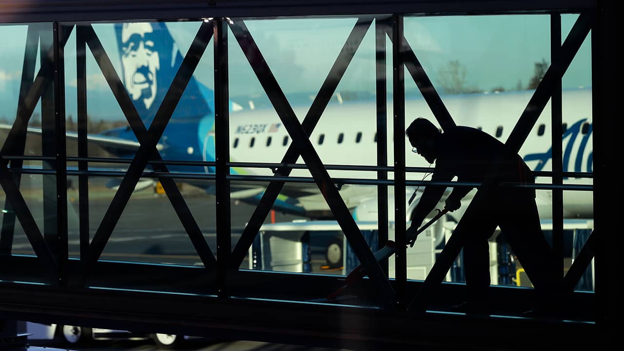 Photo of worker cleaning a jet bridge