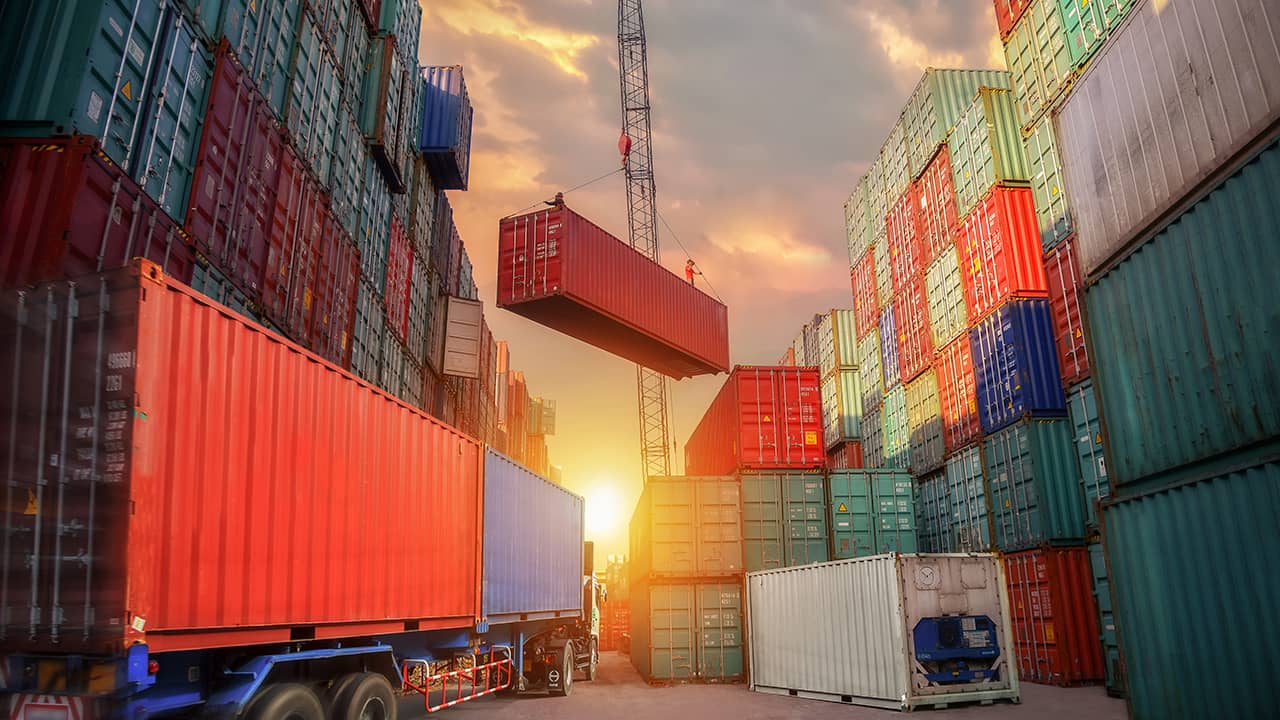 Photo of industrial crane loading container to truck