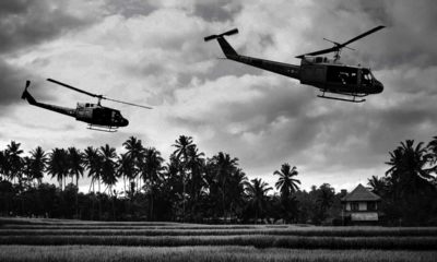 Photo of Vietnam War 'style' B&W image circa 1968 of two helicopters flying low over the rice paddies of South Vietnam looking for Viet Cong insurgents during the Tet Offensive in 1968.