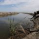 Photo of man drawing a water sample in Stockton, CA