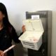 Photo of UC Davis student working to ensure placement of tampons and pads in UC Davis restrooms