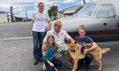 Photo of Chloe, Doug and Chase Peterson greeting their long-lost German Shepherd dog Cedar