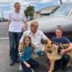 Photo of Chloe, Doug and Chase Peterson greeting their long-lost German Shepherd dog Cedar