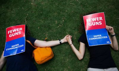 Photo of demonstrators holding hands at the NRA convention