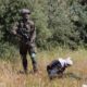 Photo of an Israeli soldier standing over handcuffed and blindfolded Osama Hajahjeh