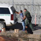 Photo of asylum seeker being taken into custody by US Border Patrol