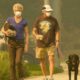 Photo of a couple and dog walking in smoke