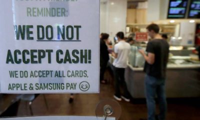 Photo of a sign informing customers that cash is not accepted