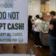 Photo of a sign informing customers that cash is not accepted
