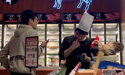 Photo of worker at the imported beef section of a supermarket