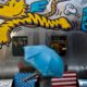 Photo of a woman walking by a painted bench in Beijing