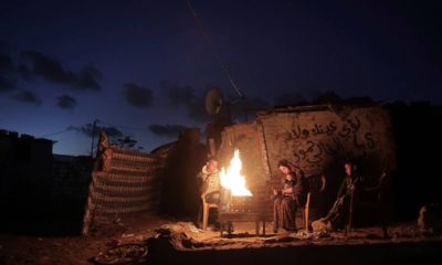 Photo of a Palestinian family outside of their makeshift house