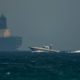 Photo of Emirati coast guard vessel passing an oil tanker