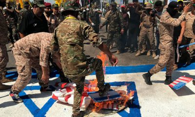 Photo of Iraqi Popular Mobilization Forces burn flags