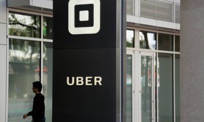 Photo of a man walking into Uber HQ in San Francisco