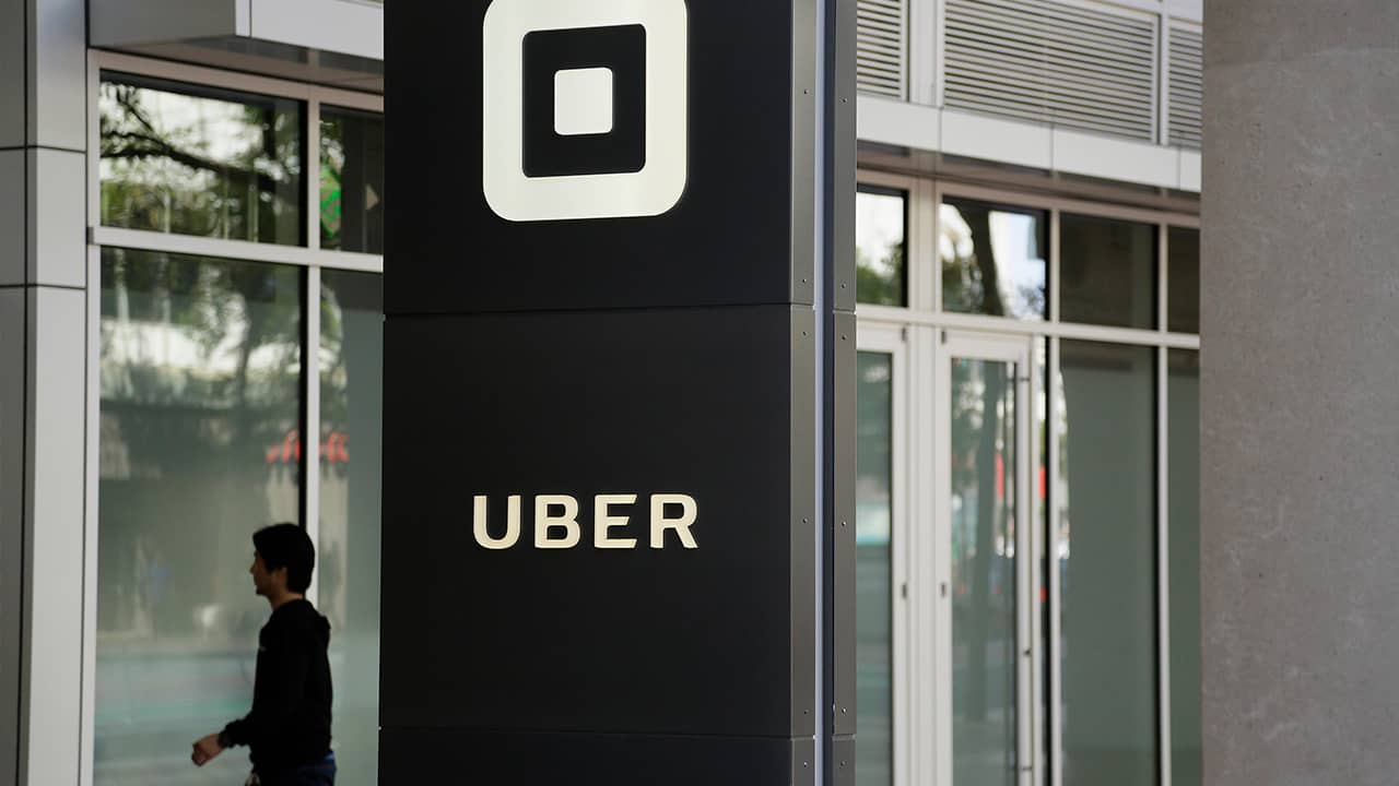 Photo of a man walking into Uber HQ in San Francisco